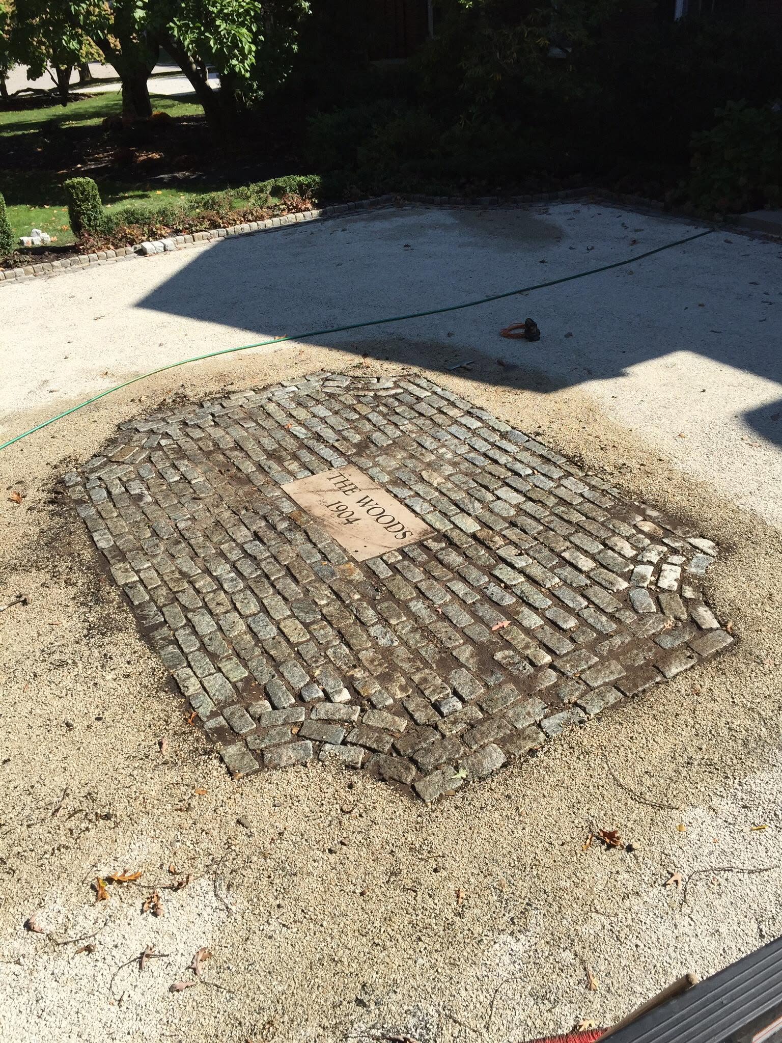 Reclaimed cobblestone apron with cut stone inset